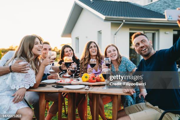 friends are taking a selfie together during a dinner party - personal perspective festival stock pictures, royalty-free photos & images