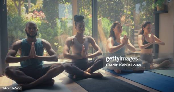 meditation, yoga and health exercise with group training in a pilates fitness studio. relax workout, breathing practice and lotus pose of people in a peace, holistic class and spiritual meditate gym - meditate stock pictures, royalty-free photos & images