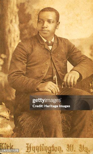 Studio portrait of unidentifed young man, seated on prop hay bale, c1870-c1879. Creator: George Wolleston Kirk.