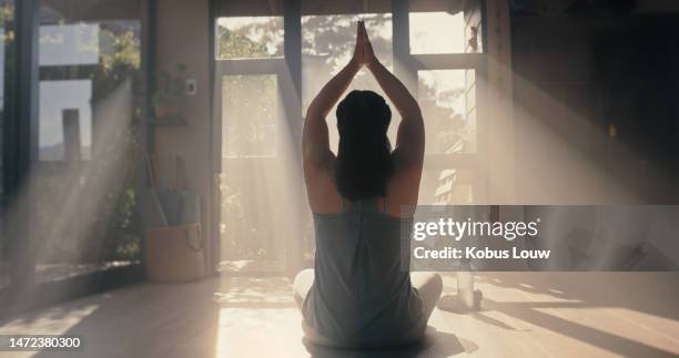 yoga, meditation and woman with fitness, zen and sunshine, spiritual and chakra balance with mindfulness. pilates, motivation and wellness in exercise studio with back, energy and healing with health - sunrise yoga stock pictures, royalty-free photos & images