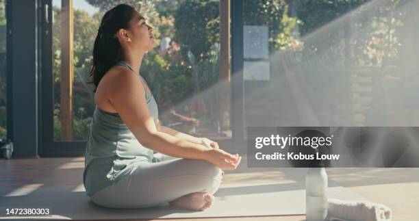 yoga, meditation and woman with exercise in sunshine, spiritual and chakra balance, mindfulness and zen. pilates, motivation and wellness in fitness studio, energy and holistic healing with health - lotuspositie stockfoto's en -beelden