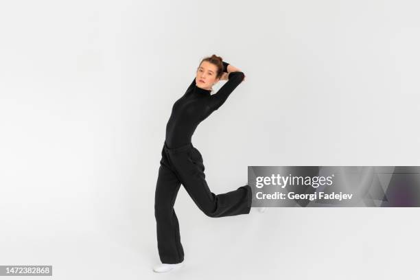 young girl, professional hip-hop dancer in a black clothes performing over a isolated white background with a plenty of copy space. - hip hopper stock pictures, royalty-free photos & images