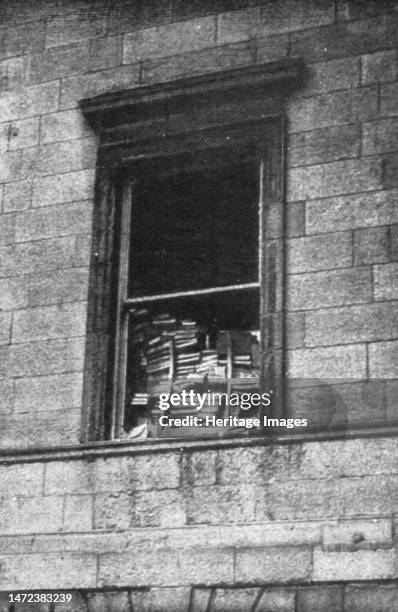 'Dublin Apres L'Emeute; Une fenetre du Palais de Justice barricadee avec les livres de la bibliotheque', 1916. From "Collection de la Guerre IV....