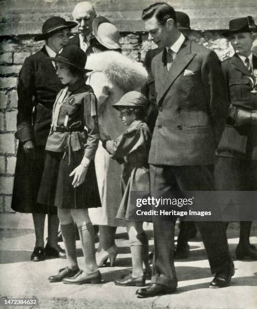 'Girl Guide Review', 19 June 1938, . King George VI and Queen Elizabeth with daughters Princess Elizabeth and Princess Margaret Rose. The two...