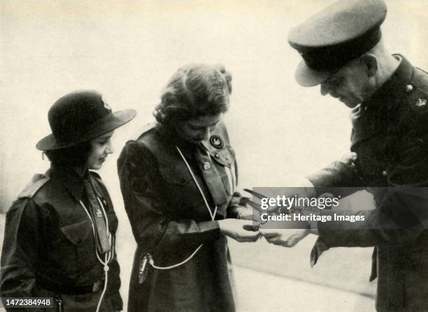 'Pigeon Post', 20 February 1943, . Princess Elizabeth and her younger sister Princess Margaret Rose, members of the Buckingham Palace Company of Girl...