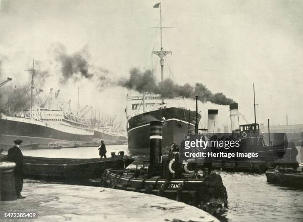 Into the Arena Where Ships Made Their Unending Entrances and Exits A Vessel Docking at the Royal Albert Dock', 1937. Ships and tugboats on the River...