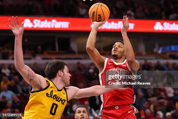 Roddy Gayle Jr. #1 of the Ohio State Buckeyes shoots over Filip Rebraca of the Iowa Hawkeyes in the second half of the second round in the Big Ten...
