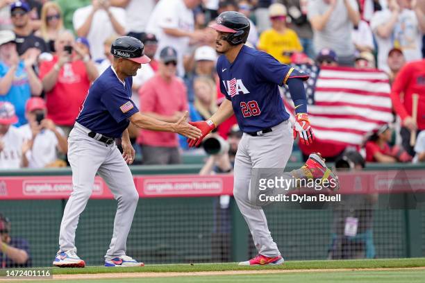 Third base coach Dino Ebel and Nolan Arenado of Team USA celebrate after Arenado hit a grand slam in the third inning against the Los Angeles Angels...