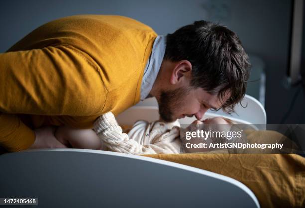 father changing clothes and diapers to his baby boy at home. - changing diaper imagens e fotografias de stock
