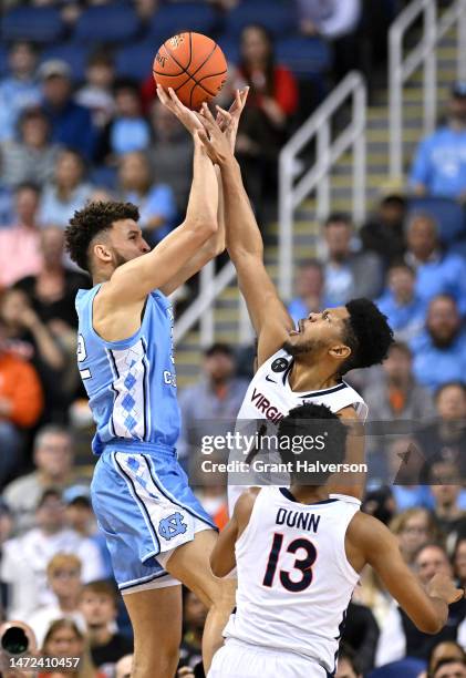 Jayden Gardner of the Virginia Cavaliers defends a shot by Pete Nance of the North Carolina Tar Heels during the first half in the quarterfinals of...