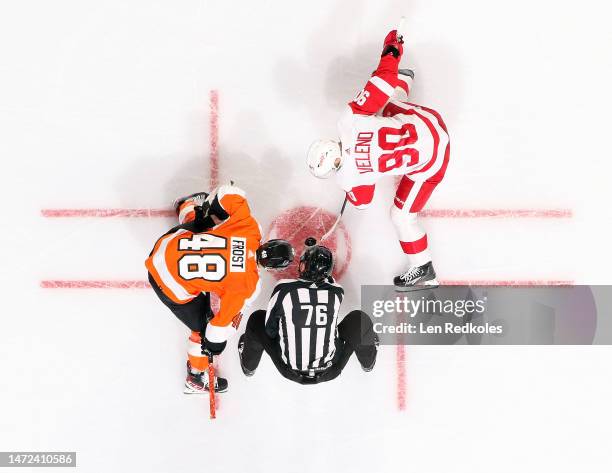 Linesman Michel Cormier drops the puck on a face-off between Joe Veleno of the Detroit Red Wings and Morgan Frost of the Philadelphia Flyers at the...