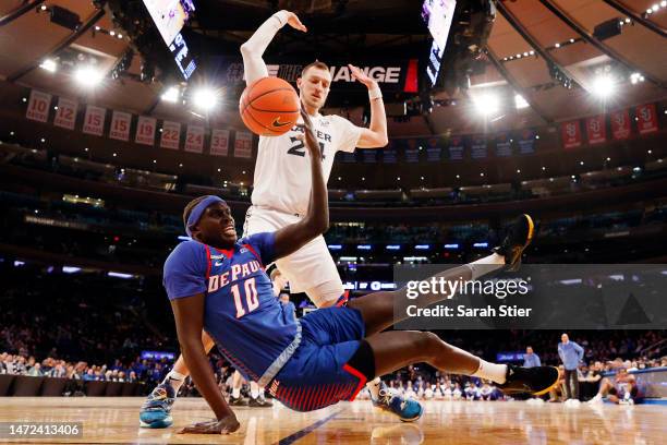 Yor Anei of the DePaul Blue Demons catches the ball as Jack Nunge of the Xavier Musketeers defends during the first half in the Quarterfinal round of...