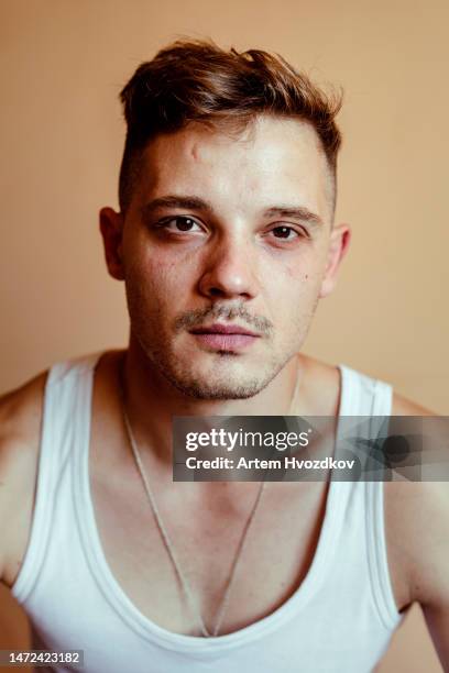 calm young male, dressed in white  sleeveless t shirt - eastern european 個照片及圖片檔