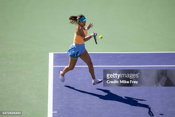 Emma Raducanu of Great Britain hits a forehand against Danka Kovinic of Montenegro in the first round of the BNP Paribas Open on March 09, 2023 in...