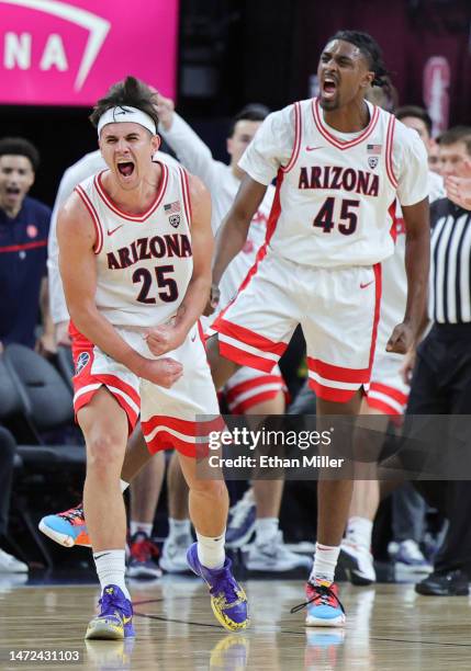 Kerr Kriisa and Cedric Henderson Jr. #45 of the Arizona Wildcats react after the Stanford Cardinal lost the ball out of bounds in the first half of a...