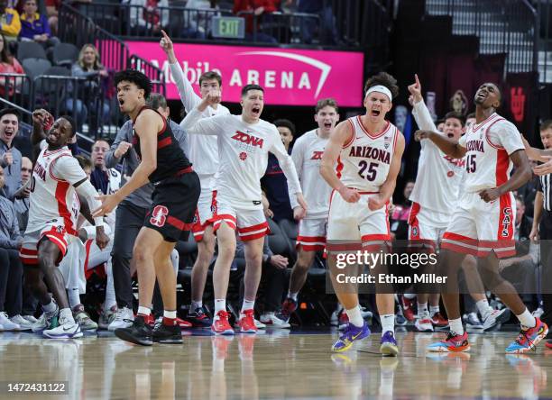 Courtney Ramey, Kerr Kriisa and Cedric Henderson Jr. #45 of the Arizona Wildcats react after the Stanford Cardinal lost the ball out of bounds in the...