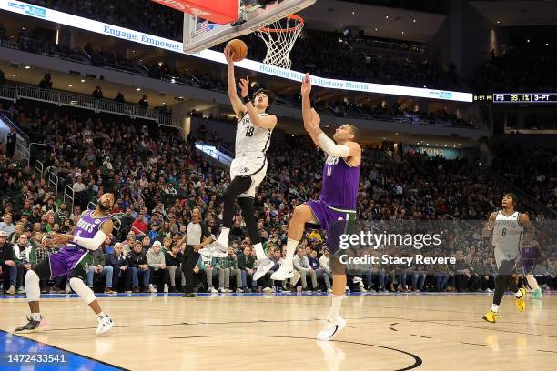 Yuta Watanabe of the Brooklyn Nets drives to the basket against Brook Lopez of the Milwaukee Bucks during the second half of a game at Fiserv Forum...