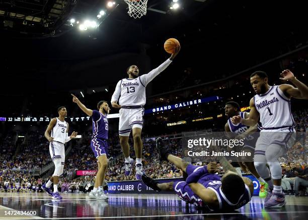 Rondel Walker of the TCU Horned Frogs falls backwards as he is fouled by Desi Sills of the Kansas State Wildcats during the Big 12 Tournament game at...