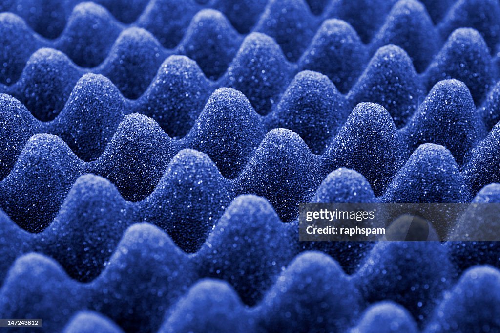 A blue acoustic foam background