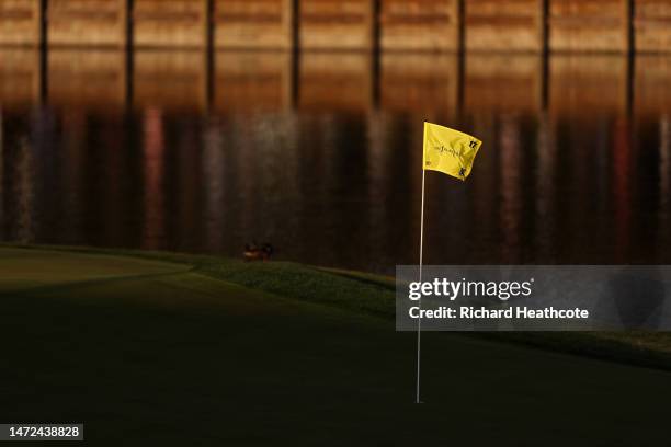 Flag blows in the breeze on the 17th green during the first round of THE PLAYERS Championship on THE PLAYERS Stadium Course at TPC Sawgrass on March...