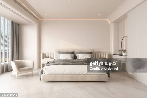 modernes schlafzimmerinterieur mit doppelbett, sessel und nachttischen - design bedroom stock-fotos und bilder