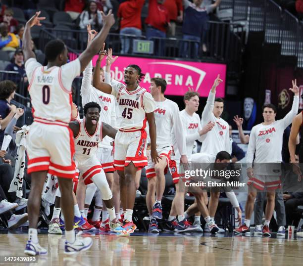 Cedric Henderson Jr. #45 of the Arizona Wildcats and teammates react after he hit a 3-pointer against the Stanford Cardinal in the second half of a...