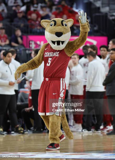 The Washington State Cougars mascot Butch T. Cougar waves during a break in the first half of a quarterfinal game of the Pac-12 basketball tournament...