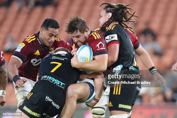 Rhys Marshall of the Highlanders is tackled during the round three Super Rugby Pacific match between Chiefs and Highlanders at FMG Stadium Waikato,...
