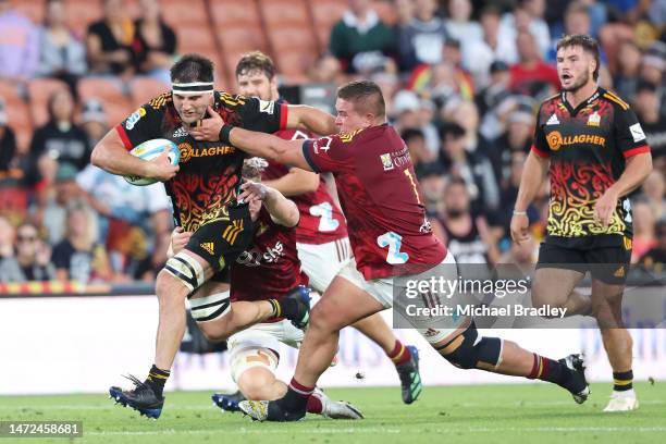 Luke Jacobson of the Chiefs fends off the tackle from Ethan de Groot of the Highlanders during the round three Super Rugby Pacific match between...