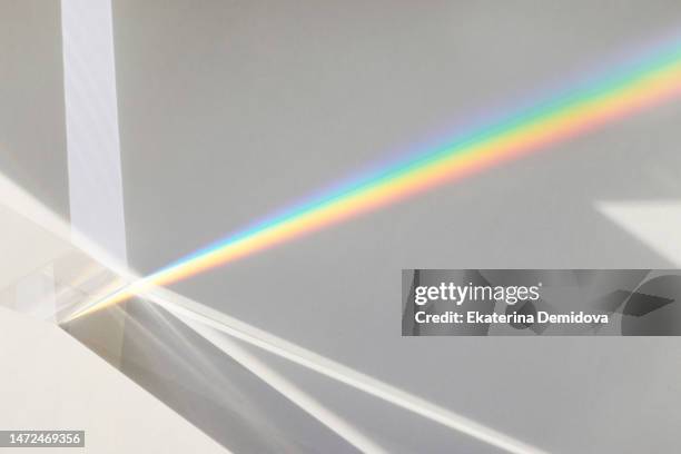 light passes through a glass prism on a white background - prisma fotografías e imágenes de stock