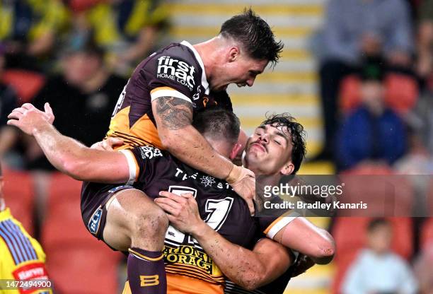 Kurt Capewell of the Broncos celebrates with teammates after scoring a try during the round 2 NRL match between the Brisbane Broncos and the North...