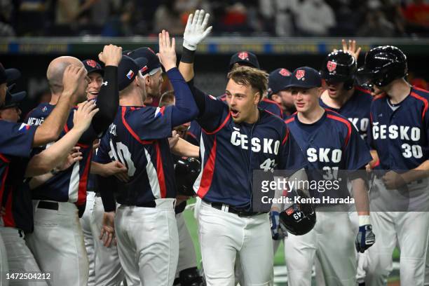 Martin Muzik of the Czech Republic celebrates with teammates after hitting a three run home run to make it 7-5 in the ninth inning in the ninth...