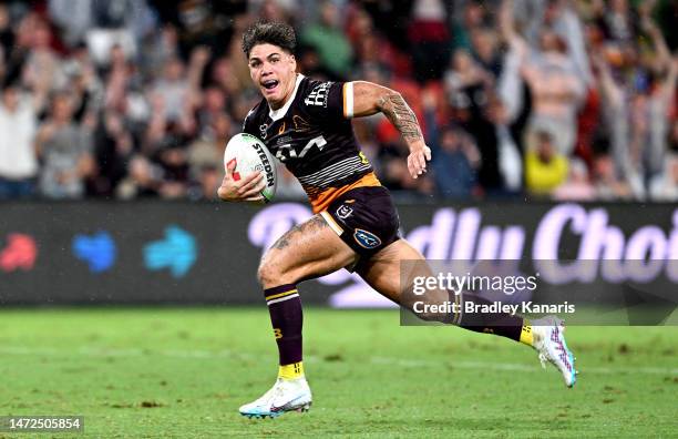 Reece Walsh of the Broncos breaks away from the defence to score a try during the round 2 NRL match between the Brisbane Broncos and the North...