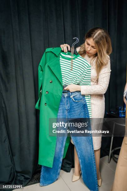 woman stylist helps to choose clothes - fashion stylist stock pictures, royalty-free photos & images