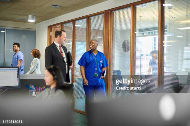 hospital administrator with senior doctor - medical sales representative stock pictures, royalty-free photos & images