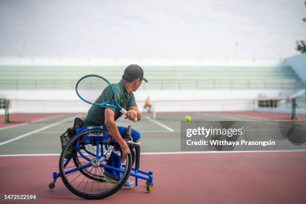 disabled tennis player hits the ball - paraplegic stock pictures, royalty-free photos & images