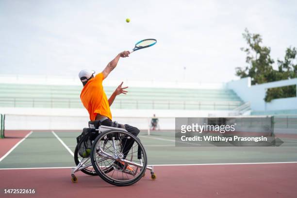 Disabled tennis player hits the ball