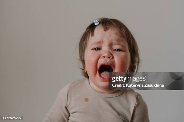 a little baby girl showing emotions, crying - crying toddler stock pictures, royalty-free photos & images