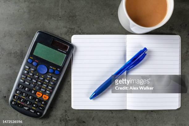 ballpoint pen on open notebook with calculator and hot drink - agenda template stock pictures, royalty-free photos & images