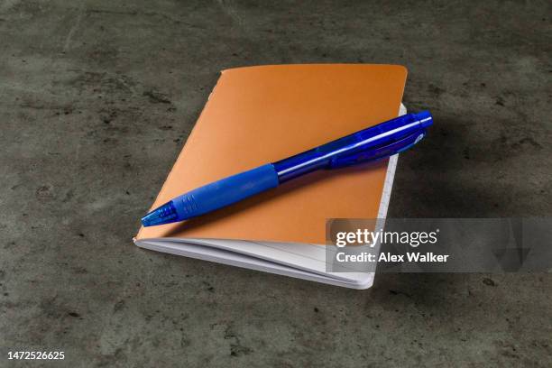 ballpoint pen on closed gold notebook with lined paper - agenda template stock pictures, royalty-free photos & images