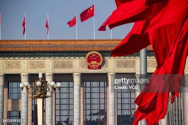 Chinese national flags flutter in front of the Great Hall of the People during the third plenary meeting of the first session of the 14th National...