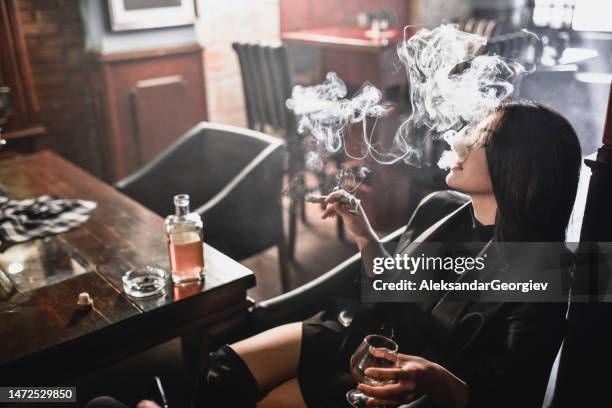 cigar smoke making strong drinks feel better for beautiful female - cigar stock pictures, royalty-free photos & images