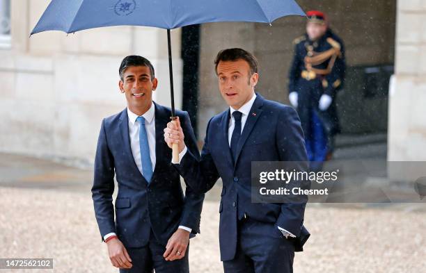 French President Emmanuel Macron accompanies British Prime Minister Rishi Sunak after the 36th Franco-British Summit at the Elysee Palace on March...