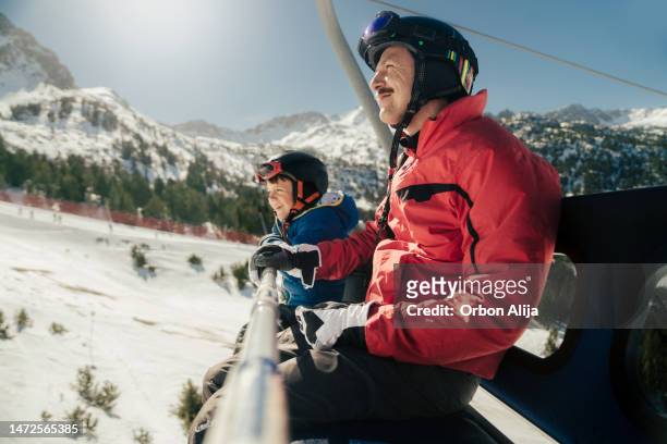 father and son skiing - andorra people stock pictures, royalty-free photos & images