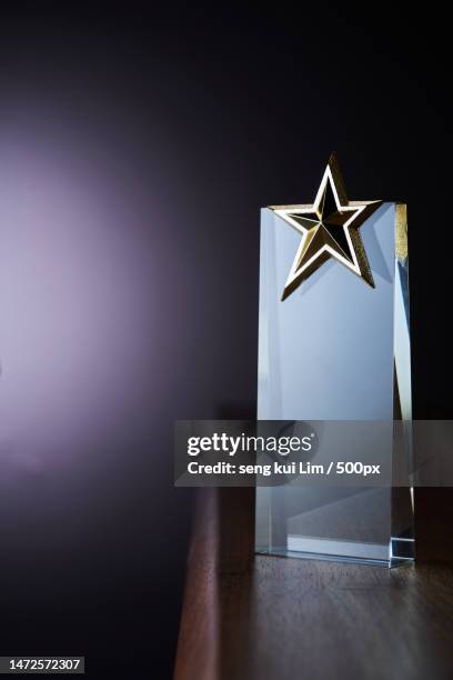 crystal trophy on top of wooden table,malaysia - trophy award isolated stock pictures, royalty-free photos & images