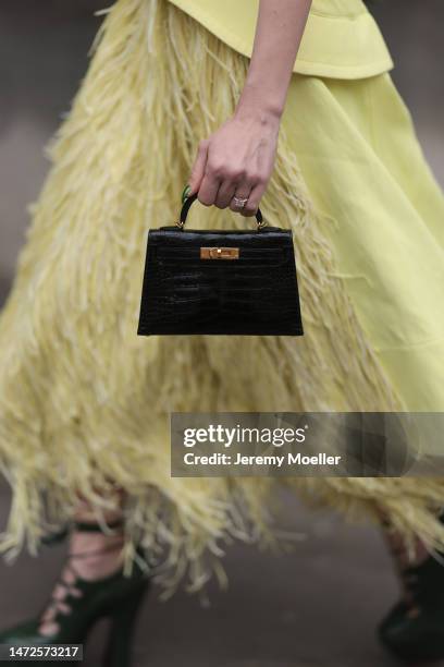 Sira Pevida seen wearing a long yellow dress, black mini Kelly Hermes handbag, green high heels , outside Hermes Show, during Pariser Fashion Week on...