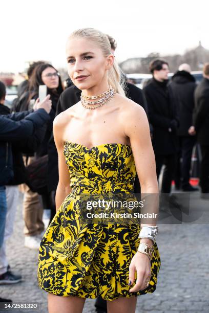 Caroline Daur wears yellow Dior mini dress with Tiffany and Co necklaces outside the the Dior show on February 28, 2023 in Paris, France.