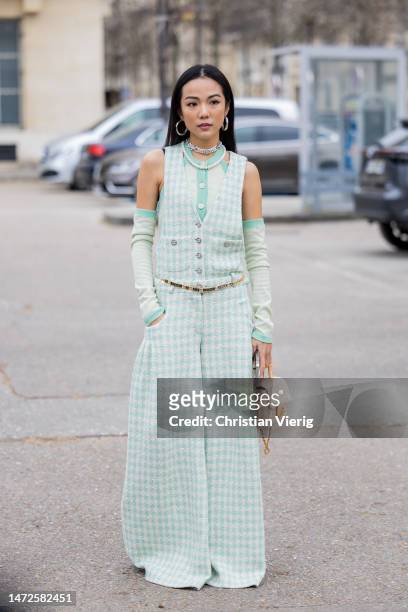 Yoyo Cao wears mint green pepita vest, necklace, gauntlets , wide leg pants, Chanel bag outside Chanel during Paris Fashion Week - Womenswear Fall...