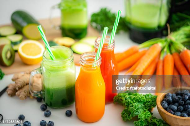 three healthy fruits and vegetables detox drinks - fresh vegetable juice stock pictures, royalty-free photos & images