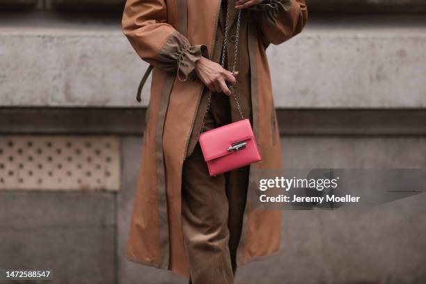 Fashion Week Guest seen wearing a brown outfit, brown jacket, brown long coat, brown cord pants and rose handbag with silver chain details , outside...